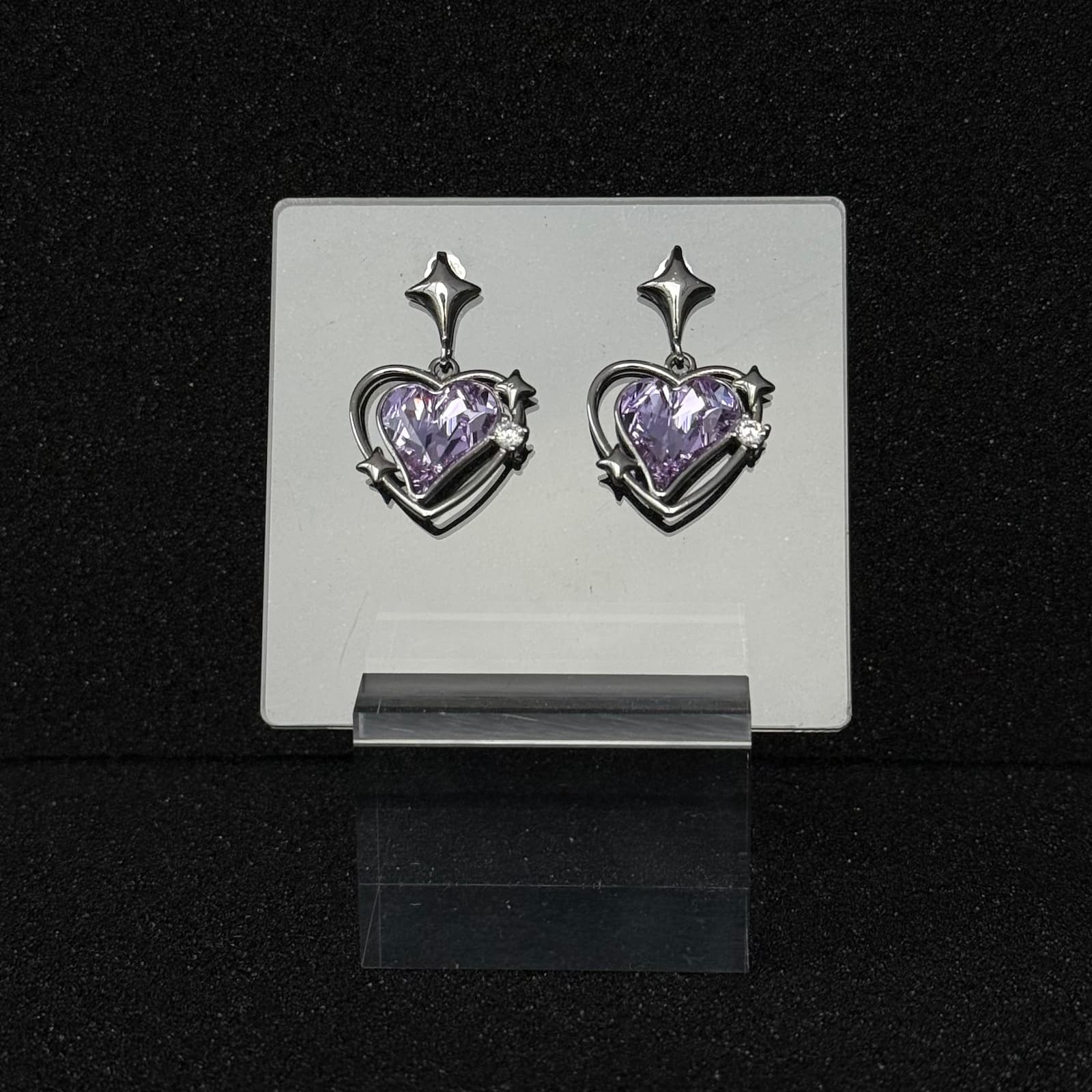 Future Spark's Zephyra Heart Earrings in 'Moonlight Amethyst', showcasing a captivating amethyst-purple gemstone that gleams with a soft, moonlit shimmer, set in sleek silver metal.