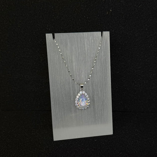 Front view of Future Spark's Nyra Teardrop Pendant in 'Opal Horizon' – a captivating opalescent finish with shifting iridescent colors and silver starburst detail.