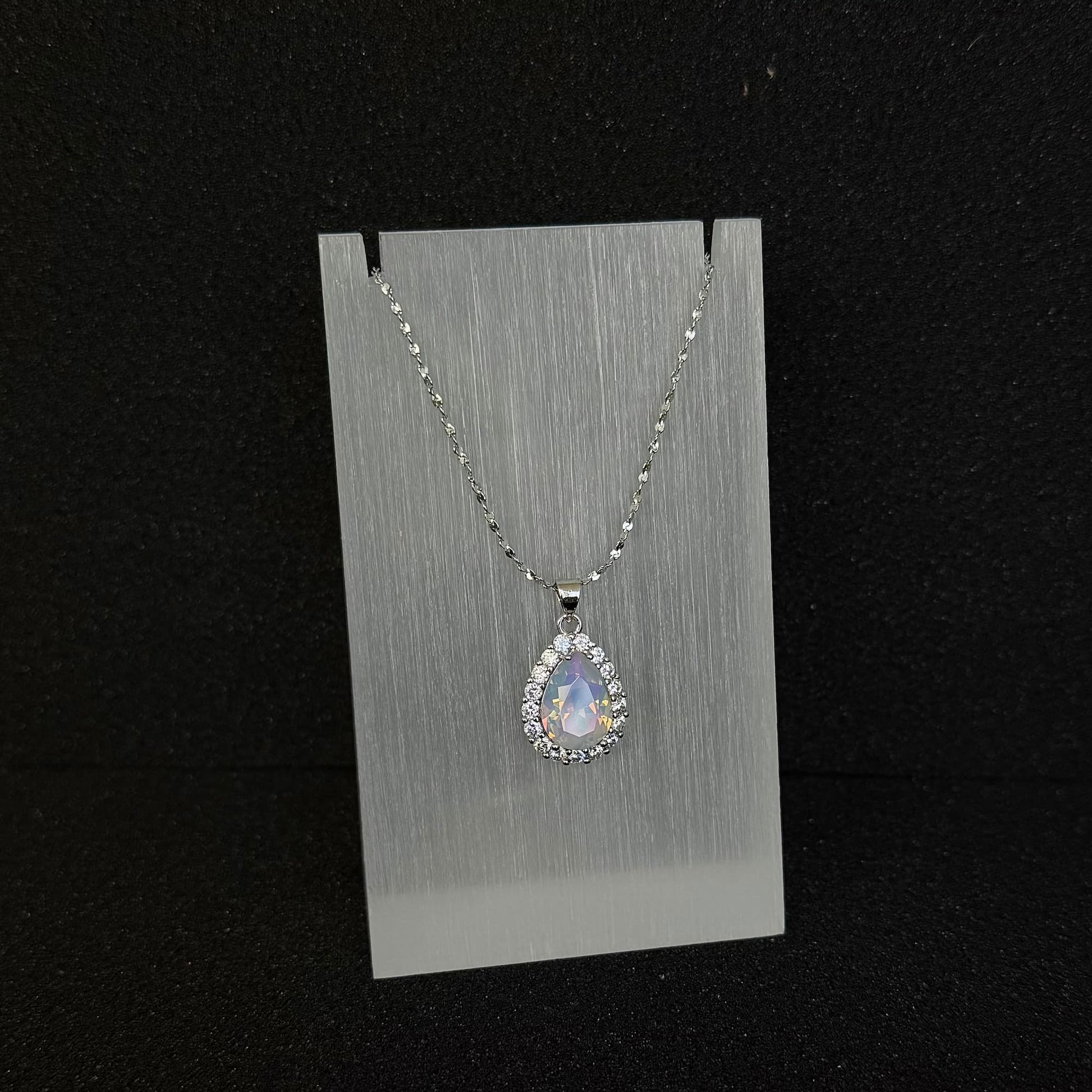 Front view of Future Spark's Nyra Teardrop Pendant in 'Opal Horizon' – a captivating opalescent finish with shifting iridescent colors and silver starburst detail.