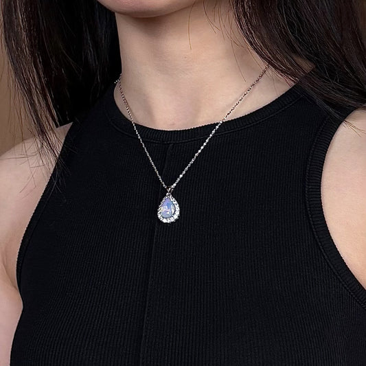 Model wearing Future Spark's Nyra Teardrop Pendant, highlighting the sparkling gemstone and silver-tone jewelry as an elegant, eye-catching accessory.