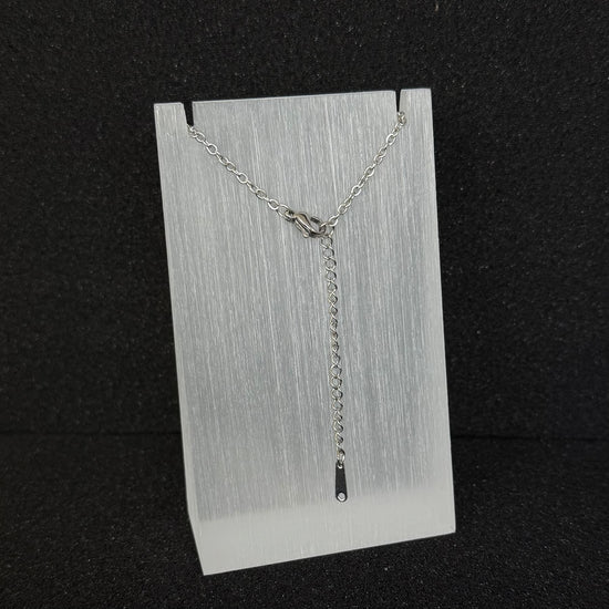 Close-up of a Future Spark necklace's adjustable clasp and extender chain, detailed in a silver-toned finish for precise length customization.