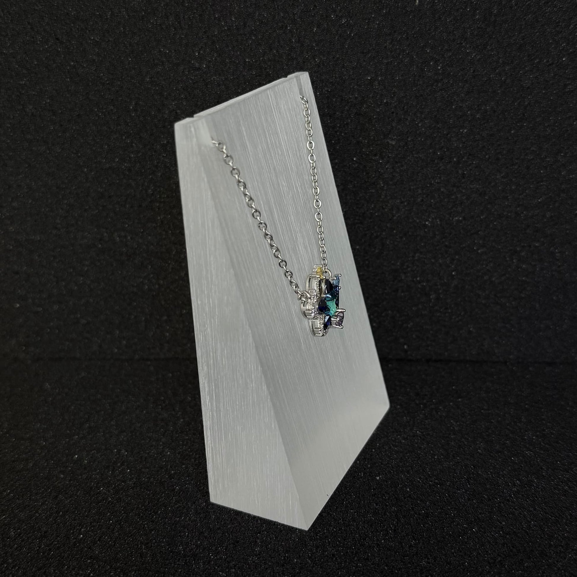 Side view of Future Spark's Seren Star Necklace, showcasing the dimensional profile of the star pendant and its detailed silver-toned craftsmanship.