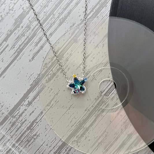 Artistic display of Future Spark's Seren Star Necklace, showcasing its celestial star pendant and sleek silver chain against a textured, mood-lit background to evoke the brand's unique, futuristic aesthetic.