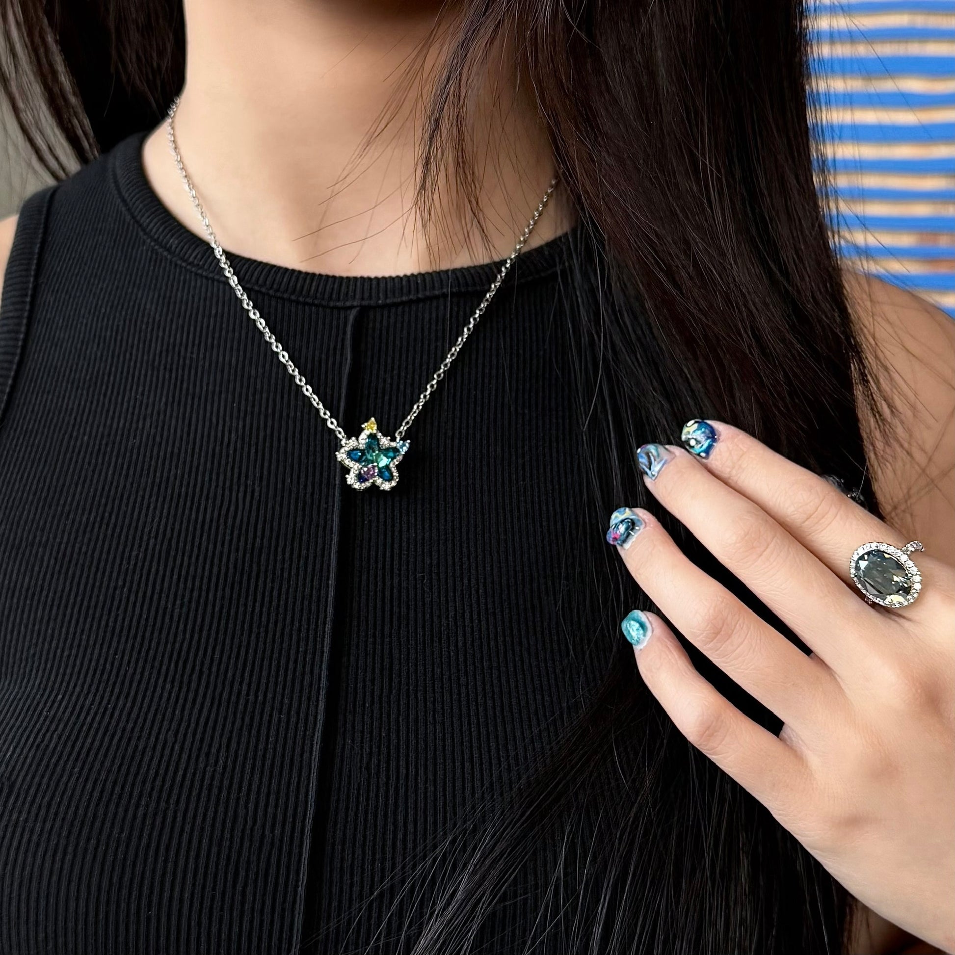 Model wearing Future Spark's Seren Star Necklace, showcasing the necklace's delicate star pendant creating a stylish, futuristic look.