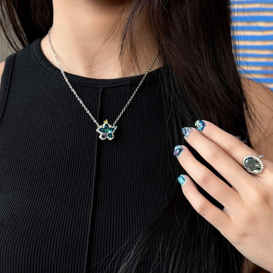 Model wearing Future Spark's Seren Star Necklace, showcasing the necklace's delicate star pendant creating a stylish, futuristic look.