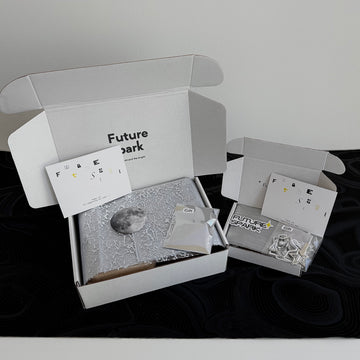 Unboxing a Future Spark order: futuristic packaging opens to reveal stunning jewelry and an array of curated surprise touches, like cosmic stickers and unique silver trinkets, creating a moment of delight.