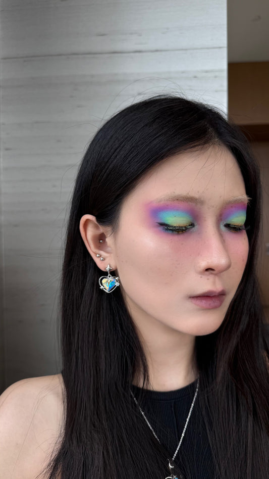 Model showcasing Future Spark's Zephyra Heart Star Earrings with multi-color crystal and sleek silver-toned finish.