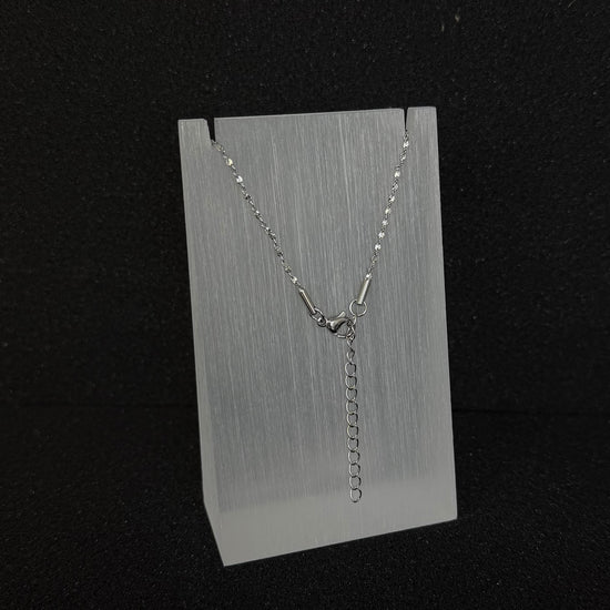 Close-up detail of the adjustable clasp and extender chain on a Future Spark silver-toned necklace, allowing for versatile length adjustment.