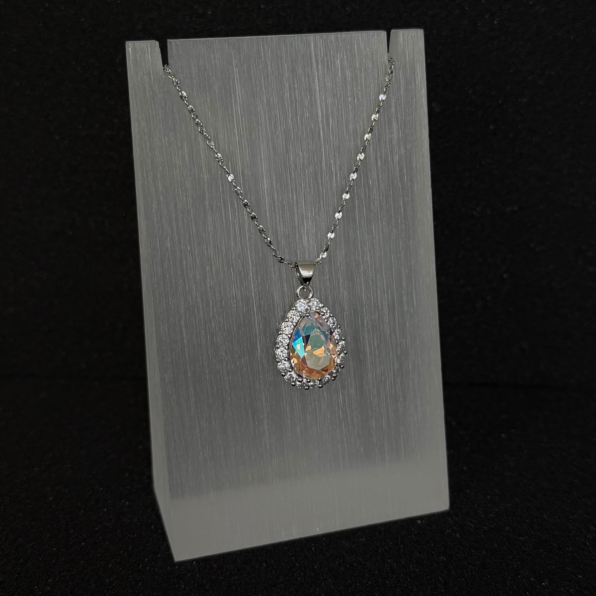 Front view of the Future Spark Nyra Teardrop Pendant in ' Celestial Dew', showcasing its soft pink rainbow gemstone with ethereal, nebula-like swirls and intricate silver detail.