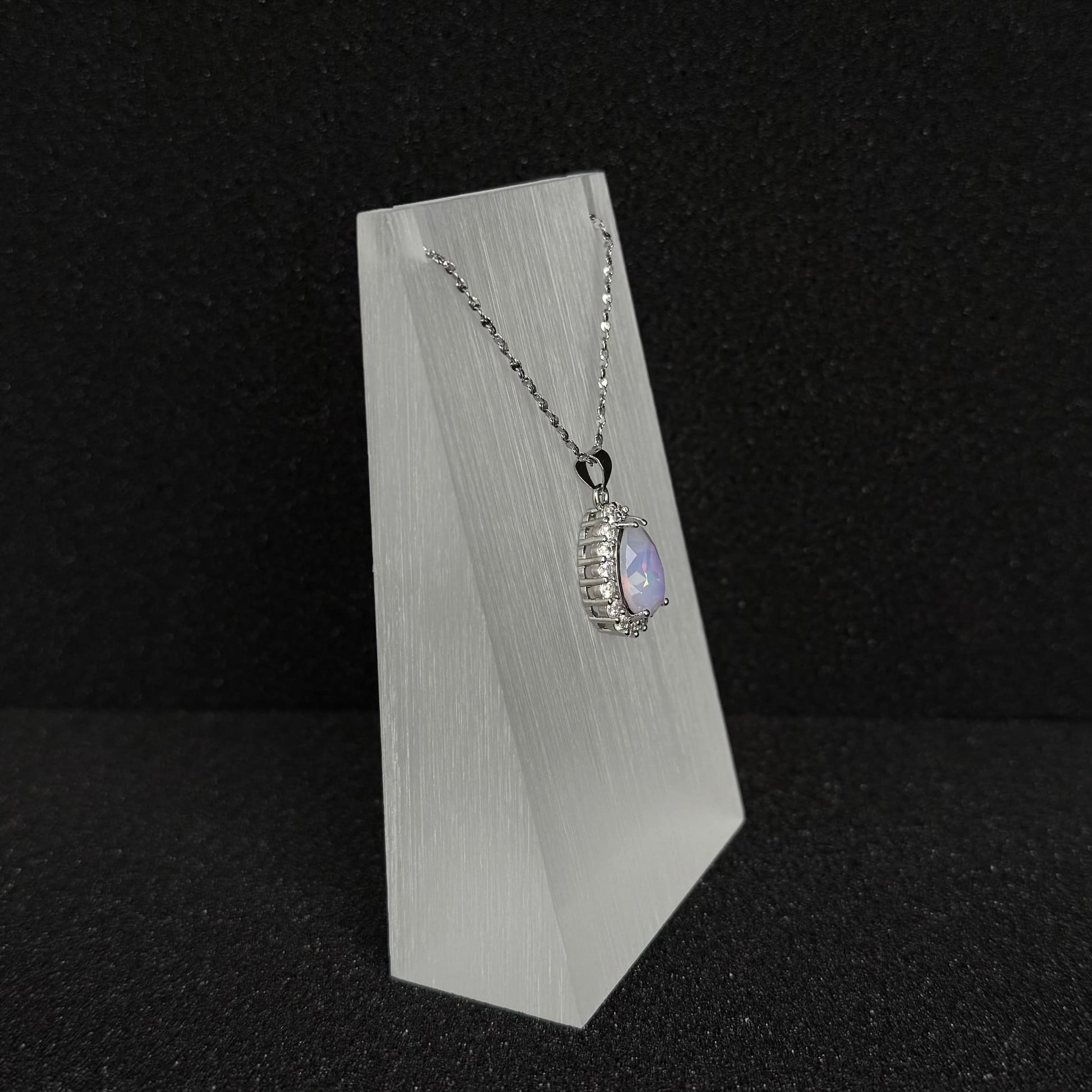 Future Spark's Nyra Teardrop Starburst Necklace, side profile, highlighting the multi-dimensional design of the pendant and its silver-toned finish.