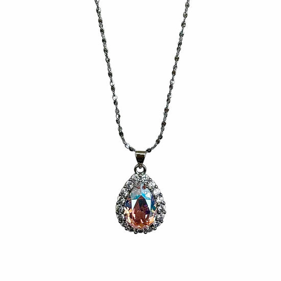 Product image of the Nyra Teardrop Starburst Necklace by Future Spark, highlighting its color-shifting iridescent stone, intricate starburst design, and silver chain, on a white background.